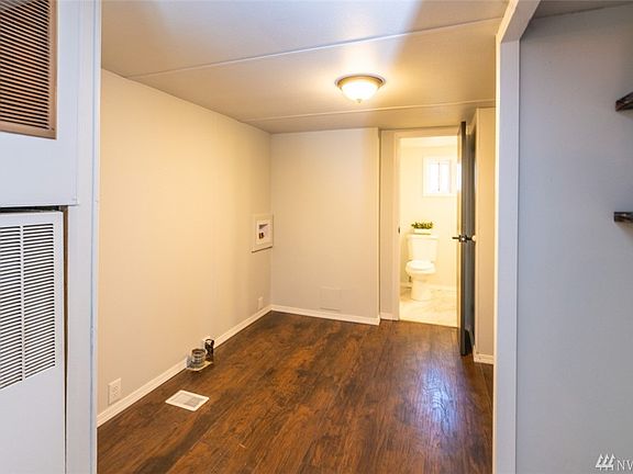 Utility room that leads to half bath and back entrance 