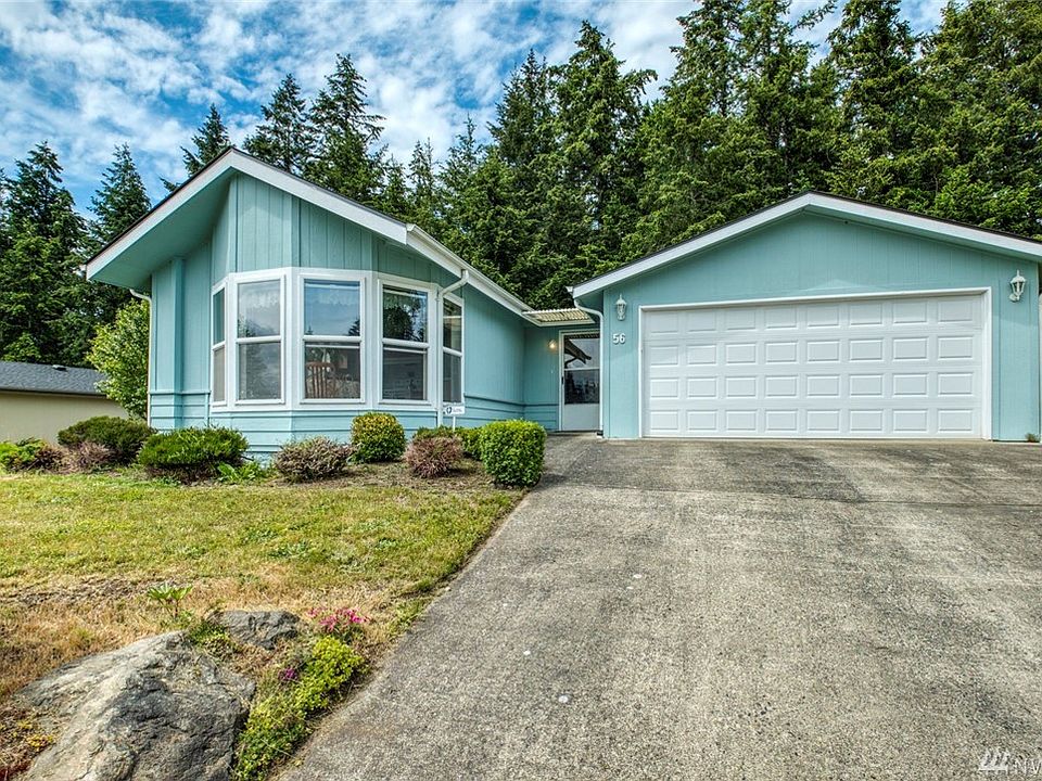 Large two car garage has extra shop space.