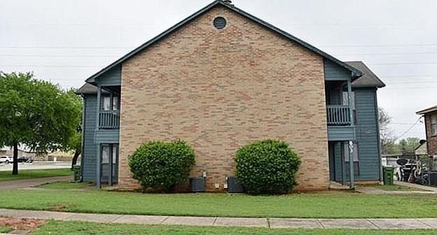 View from street. Apt B entrance and carport parking on backside.