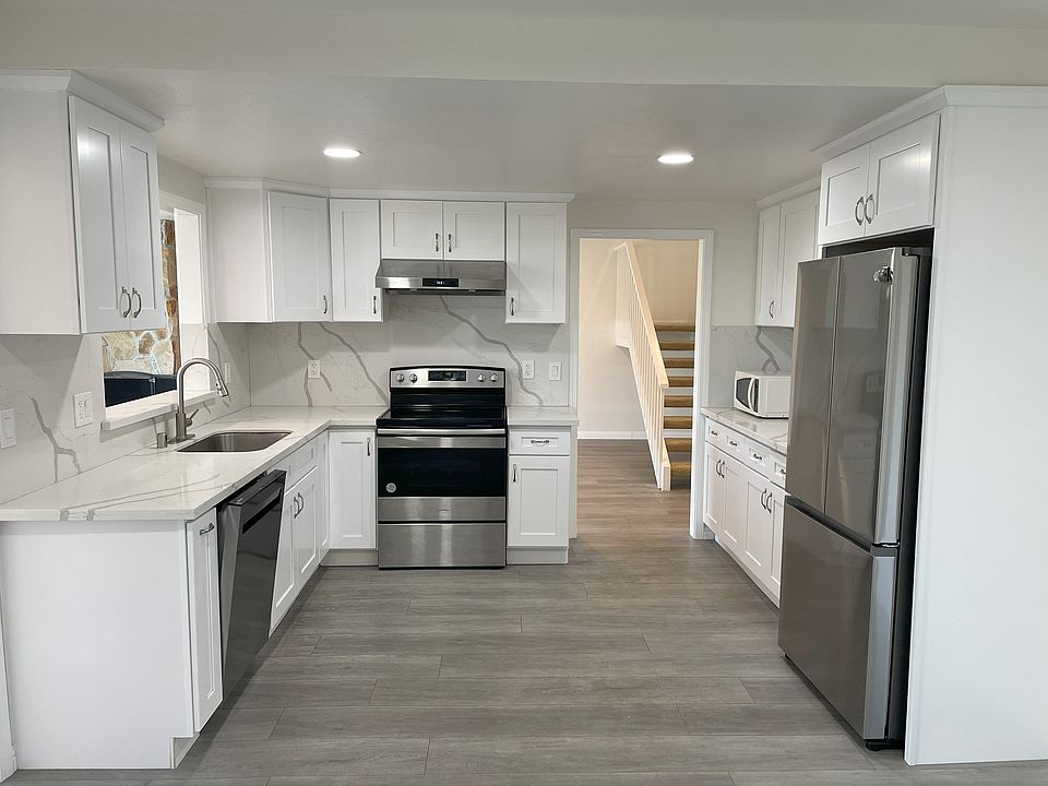 Open kitchen with brand new granite countertop, all new kitchen cabinets, steel appliances, wall plugs throughout