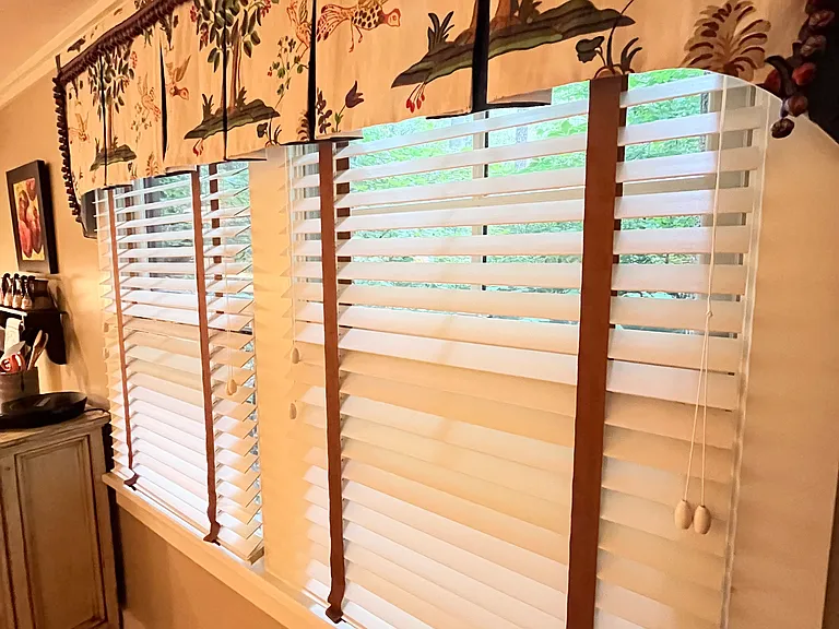 Wooden blinds and custom linen window treatments.