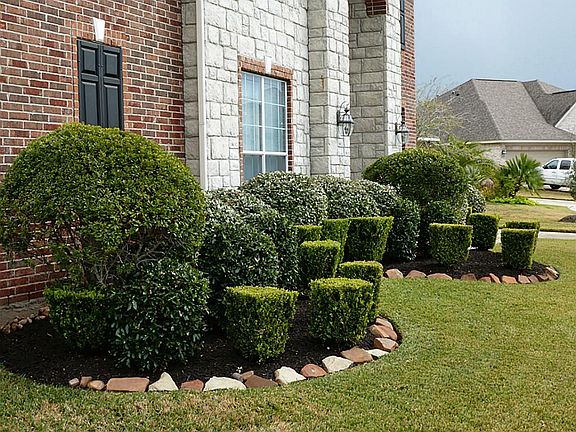 Front lawn is lushly landscaped.
