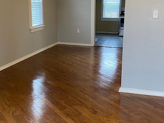 living space with new renovated wood floors, new windows and blinds, new paint
