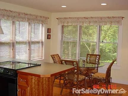 Bright sunny kitchen in main house
						:
						New cherry cabinets, blk/stainless appliances, solid oak fls, views to forest.