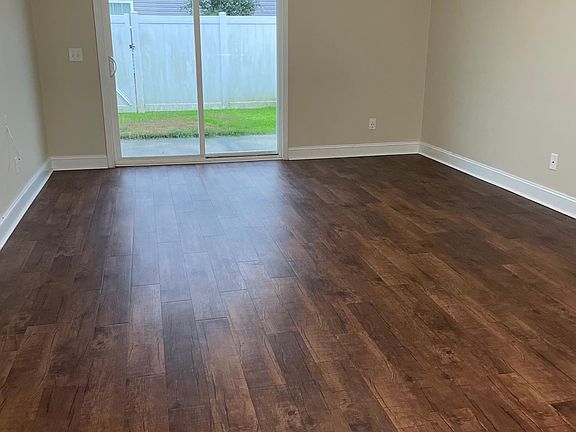 Very Long open concept Living room with sliding door to backyard.