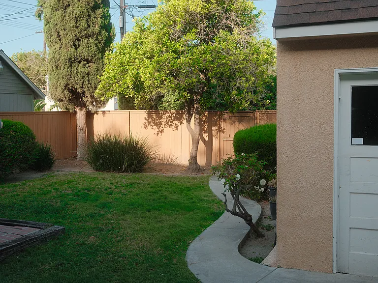 Backyard. Fenced. Brick patio area. Detached large garage.