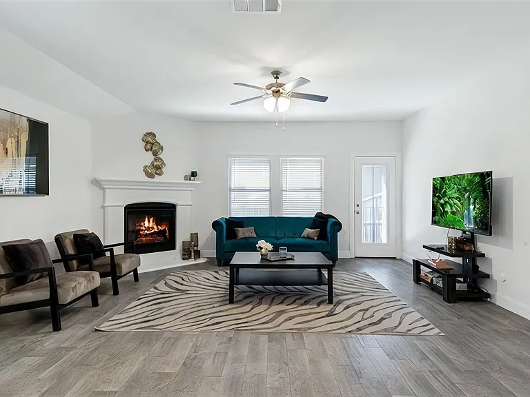Bright, roomy sitting area with fireplace