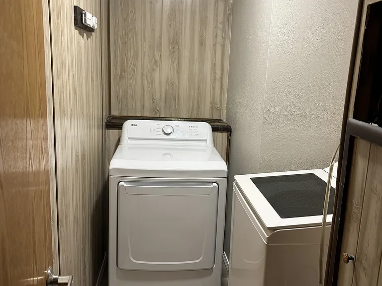 Laundry room with brand new LG smart washer and LG dryer