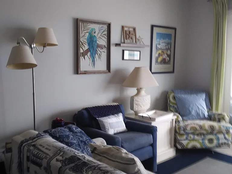 Another view of the living area from the back of the room. The chair in the corner is a swivel rocker.