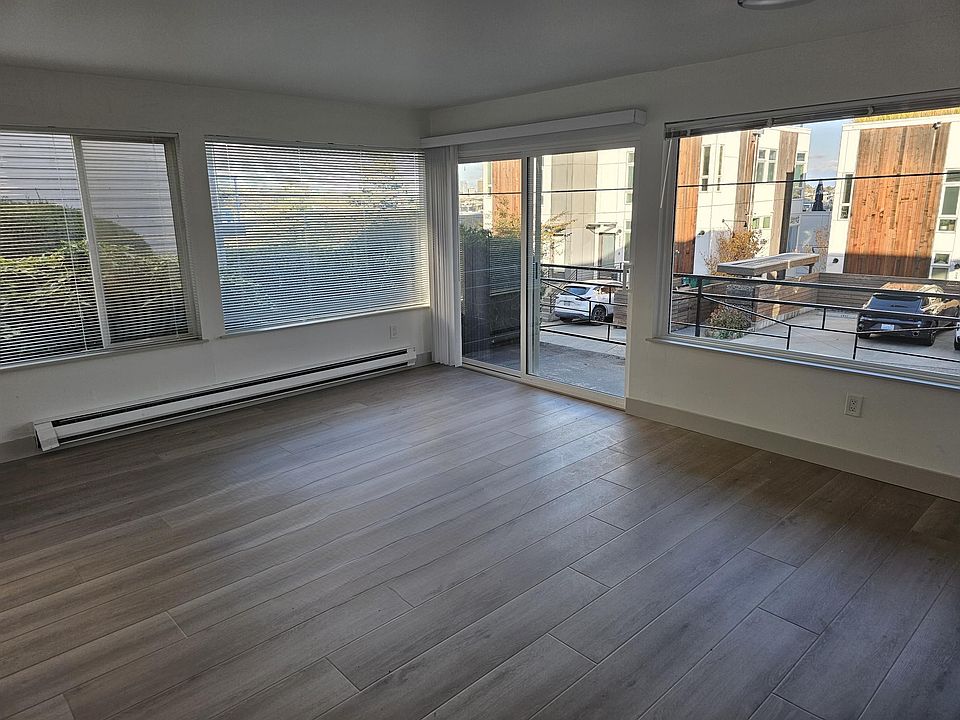 Living room with sliding door to deck and territorial views. Lot's of natural light and easy access to downtown, UW, and public transportation.