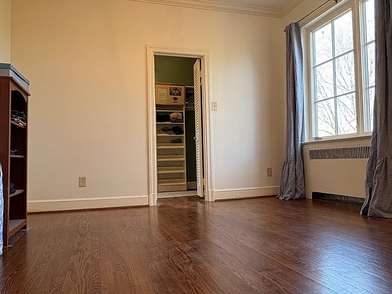 Sitting room/lounge with walk-in closets (two) off the primary suite. We used as a nursery with its access to a second bathroom (and alternate exit into the rest of the home.)