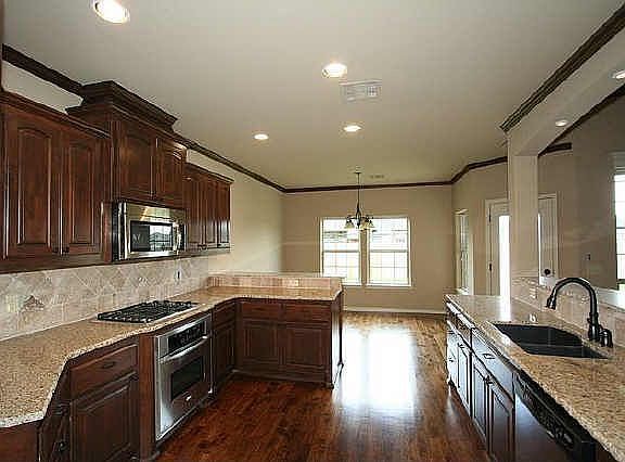 Kitchen with hardwood floors and stainless appliances