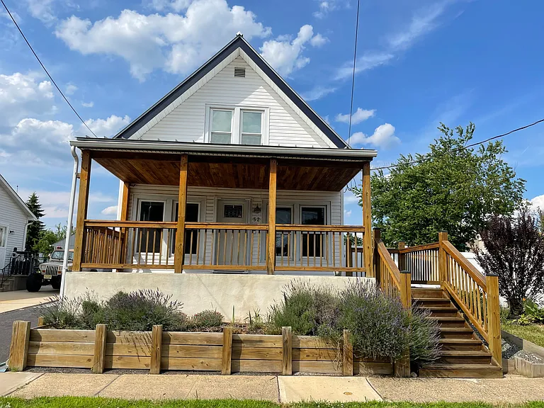 Welcoming covered front porch and main entrance with great curb appeal.