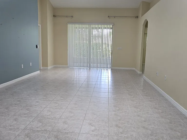 View of Living Room facing Screened Patio and Backyard