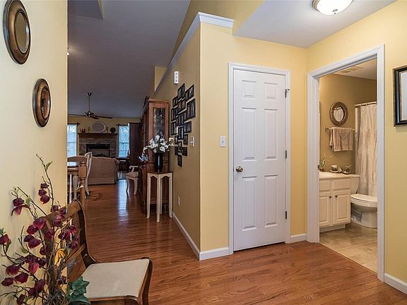 There is a coat closet and full bath with tub shower combination