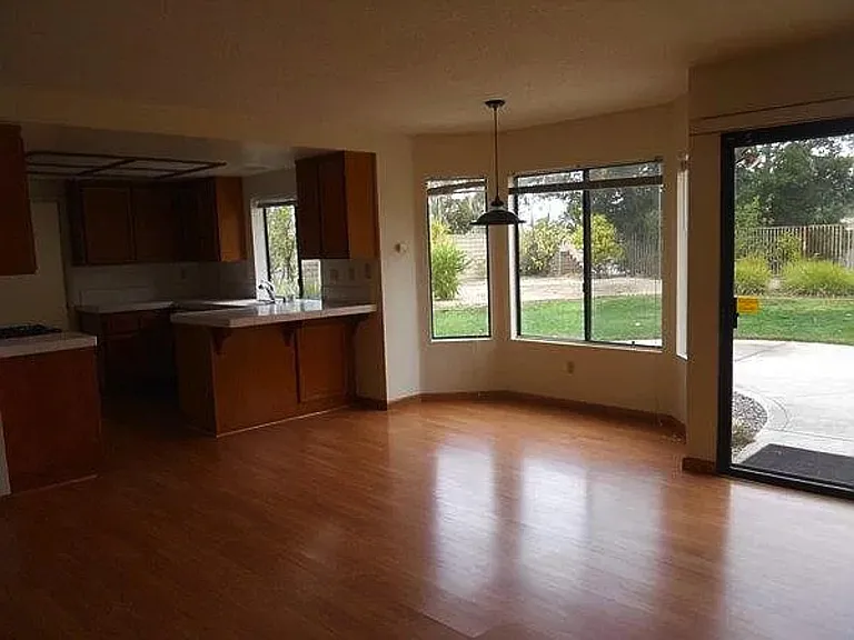 Family room with backyard views and fireplace (hidden to the right) - cleared