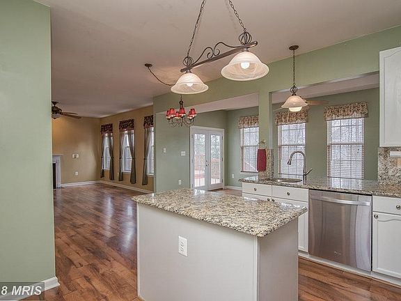 Kitchen opens to sunroom and family room