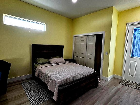 Bright, comfortable living area with full bed and closet