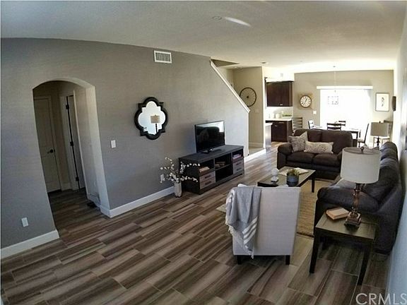 Enjoy entertaining in this lovely open living room with beautiful tile floors