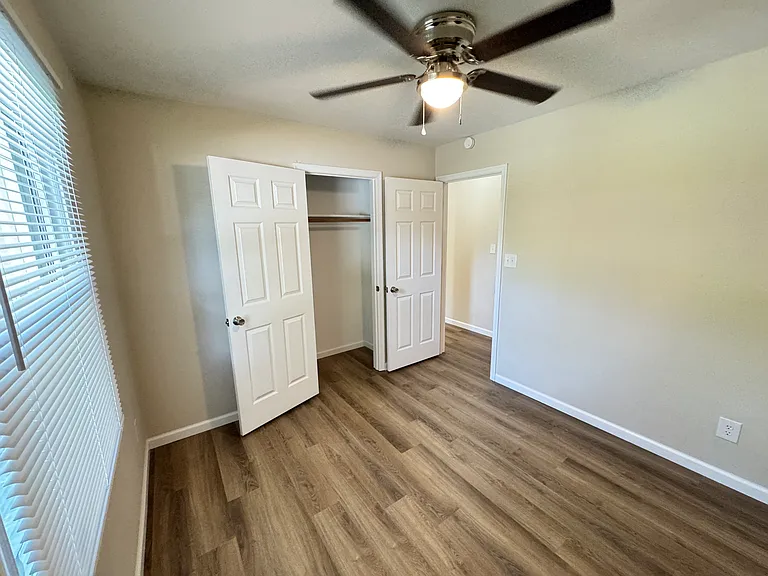 Bedroom 1 - from back corner. Looking at closet and door.