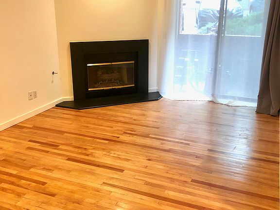 living room with fireplace and patio