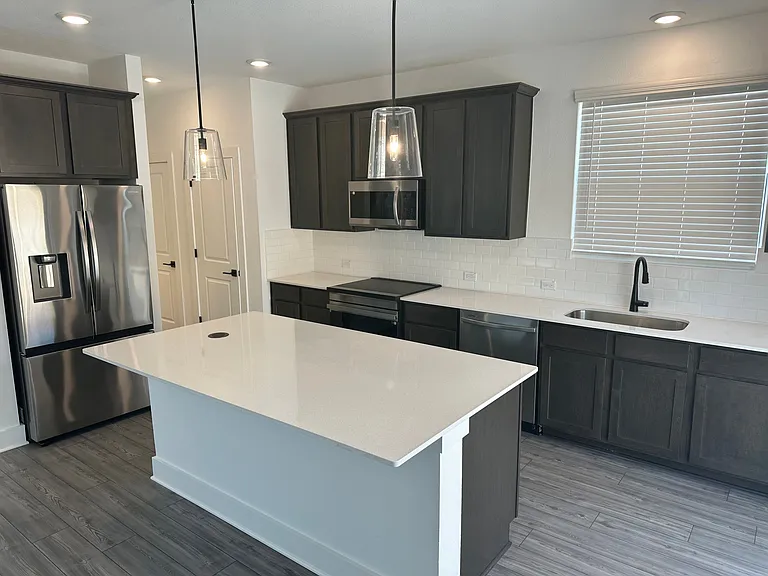 Kitchen with solid surface countertops and stainless steel appliances