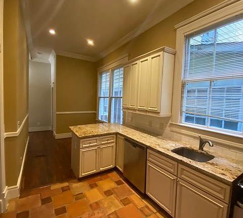 Kitchen with dining area. Granite countertop, dishwasher.