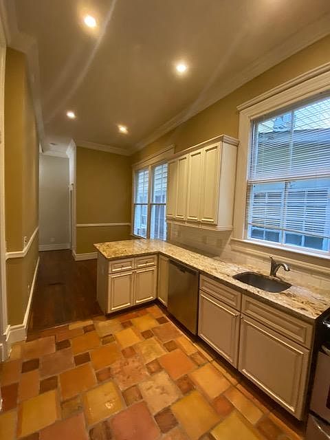 Kitchen with dining area. Granite countertop, dishwasher.