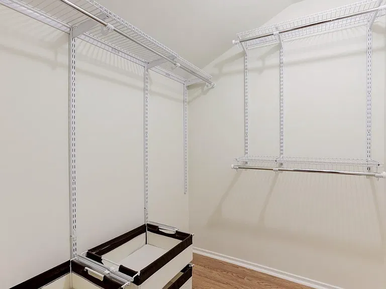 The walk-in closet offers abundant space and organization, featuring custom shelving, hanging racks, and built-in drawers to keep your wardrobe neatly arranged.