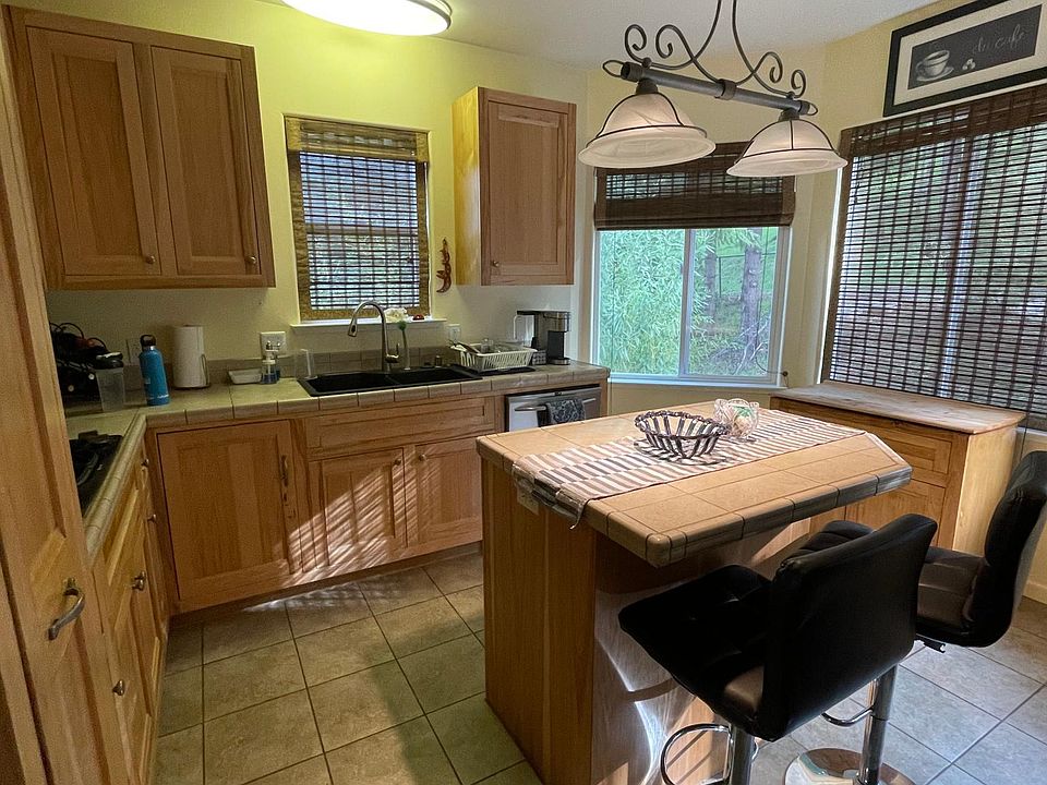 Kitchen with Island, stainless steel appliance and 4 windows for lots of natural light