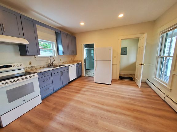 Kitchen showing entry to foyer on right and bathroom on the left