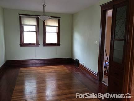 Dining room with built-in cabinet
						:
						refinished hardwood floor, fresh paint and new light fixture for dining room.