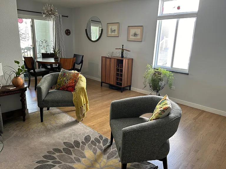 large enclosed patio with ceiling fan, beautiful tree provides privacy