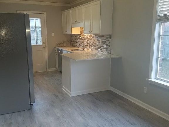 Newly remodeled kitchen with quartz countertop, new appliance, new fixtures and modern blacksplash.