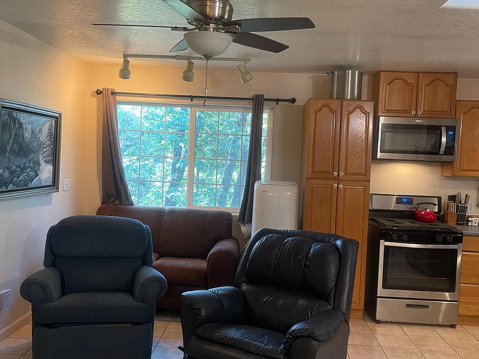 Two recliners, loveseat through the window airconditioner. Gas stove and microwave
