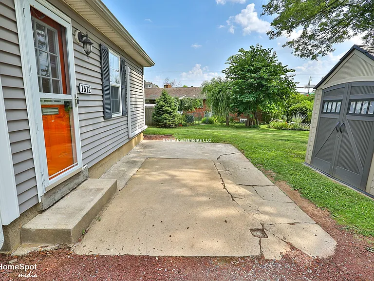 View of the parking spot and storage shed