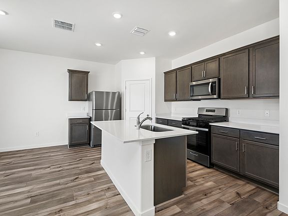 The kitchen comes with a full suite of stainless steel appliances.