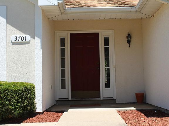A cheerful red door greets neighbors and guests