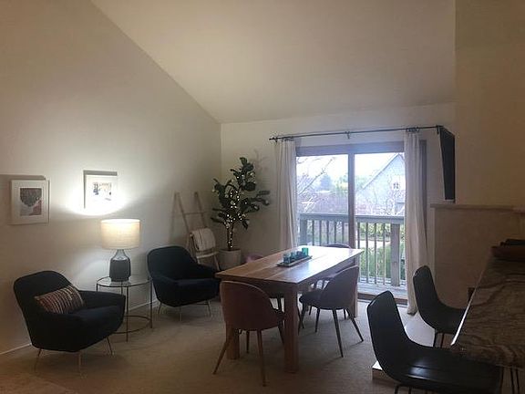 Living room with folding tv above fireplace.