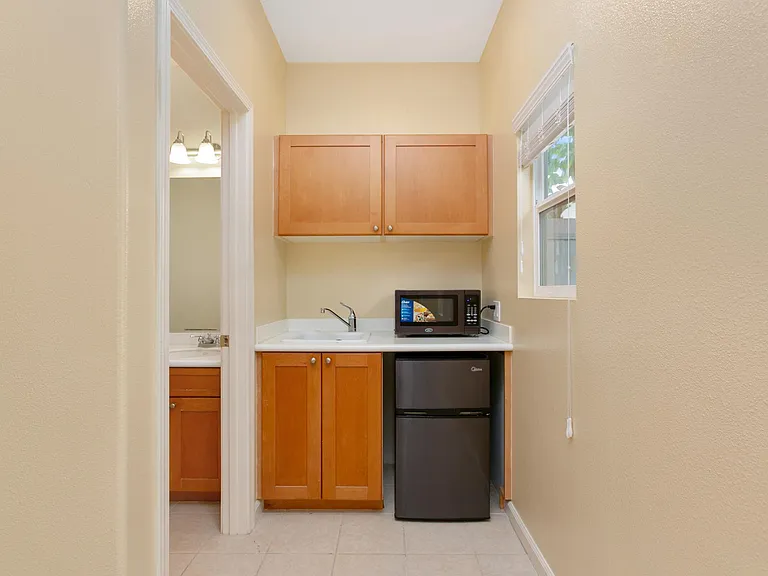 Wet bar with a small fridge inside the studio or in-law suite.