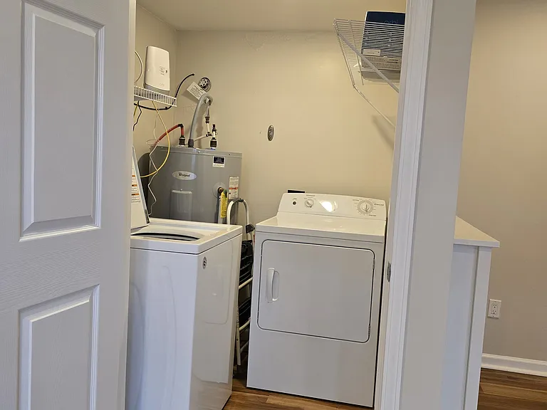 Utility room, full size washer and dryer for use.