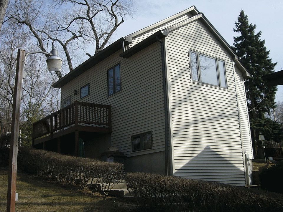 House, small deck and patio view.