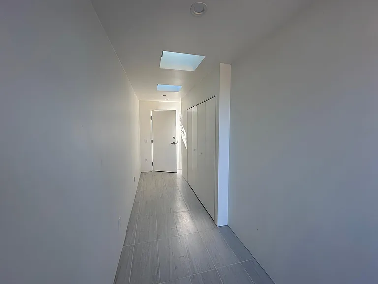 The ancillary storage space suitable for extensive side-wall shelving.