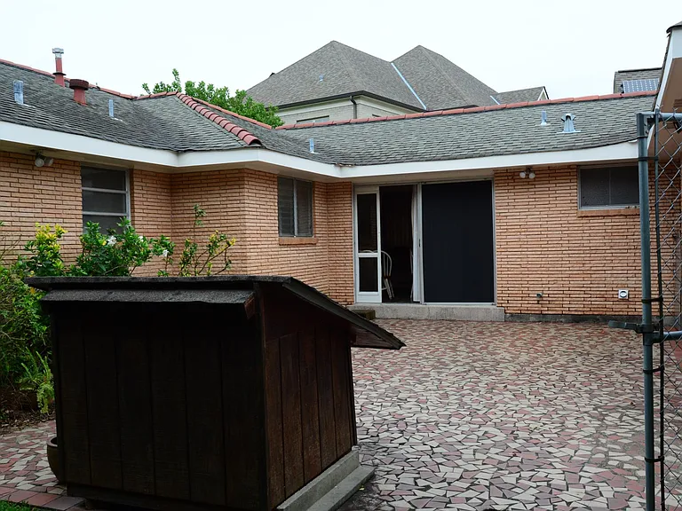 Facing north (towards Lake Pontchatrain). Sliding glass door from den. Street and second driveway to the right.