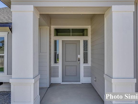 Front Door Covered Entry with Transom and Side Windows.