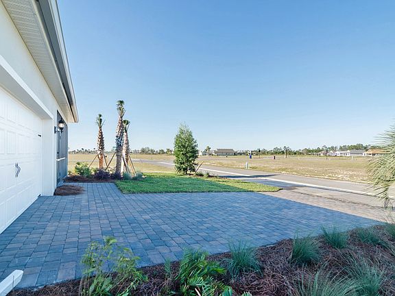 Rear exterior with garage and paver driveway