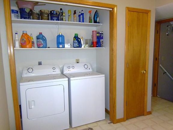 Main Floor Large Laundry Room with Pantry and Clothe Hanging
