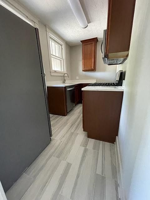 The flooring, cabinets and countertops are similar in the remodeled apartments.