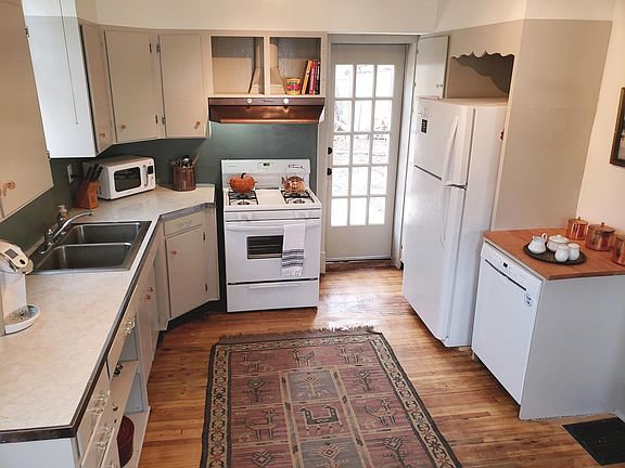 Kitchen - with all new appliances - gas range, microwave, dishwasher and fridge. Door to patio garden.