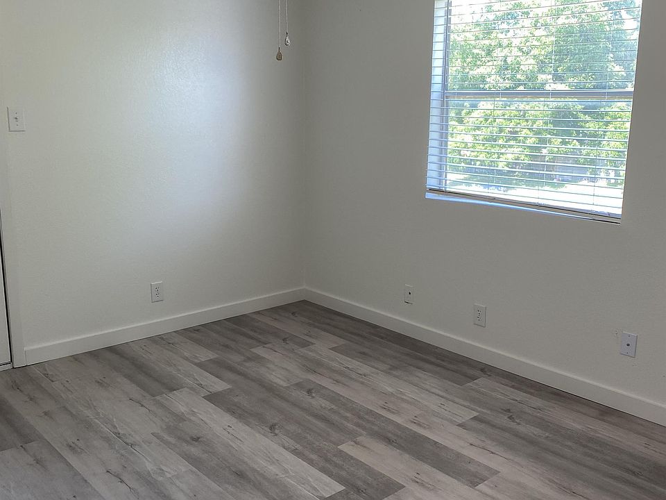 Bedroom 1 with ceiling fan, 2 closets and access to private balcony